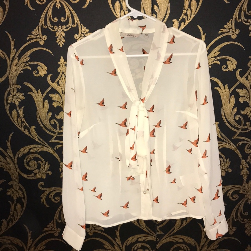 White blouse with light brown bird design